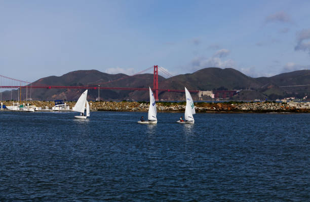 San Francsico, California, United States - March 30, 2014: Small Sailboats On Bay With Golden Gate Bridge In Background Blue Cloudy Sky