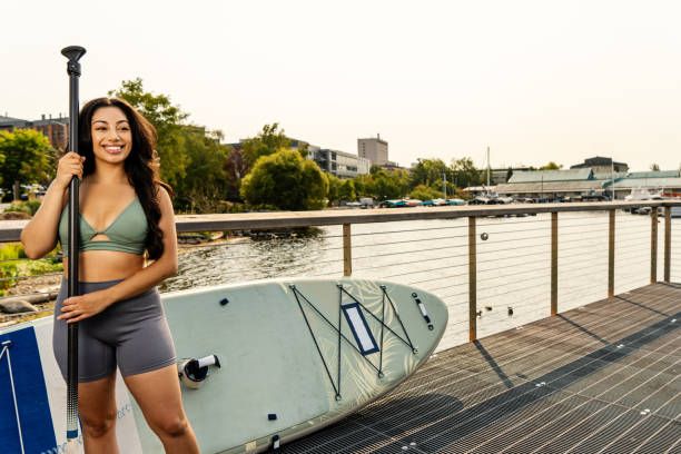 A portrait of a paddle boarder on the shore of the lake.  This was taken on Portage Bay in Seattle Washington State.