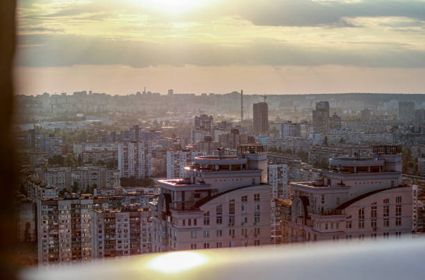 Kyiv basks in the warm glow of the setting sun, casting a golden hue over the urban landscape as the day transitions into evening. A tranquil moment in the bustling capital.