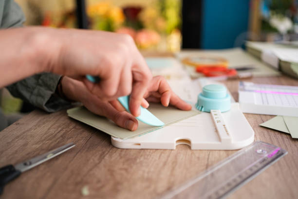 istock Small business owner making wedding invitation cards while working in her flower shop 2168671871