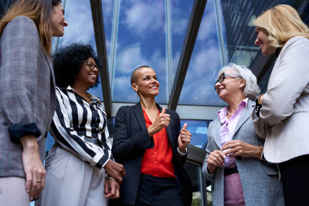 istock Low angle. Group diverse smiling business women gathered talking happy making gestures affirmation. 2168675165