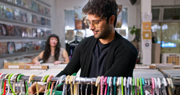 Two young adults shopping in a record store in Boyle Heights, Los Angeles, California.