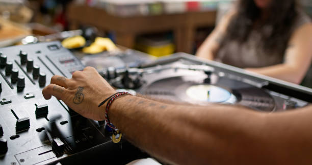 Two young adults using a turntable in a record store in Boyle Heights, Los Angeles, California.