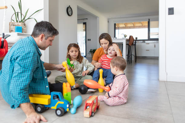 istock Parents with three small children playing on the floor 2168685783