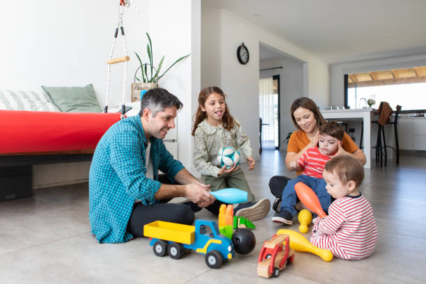 istock Parents with three small children playing on the floor 2168685838