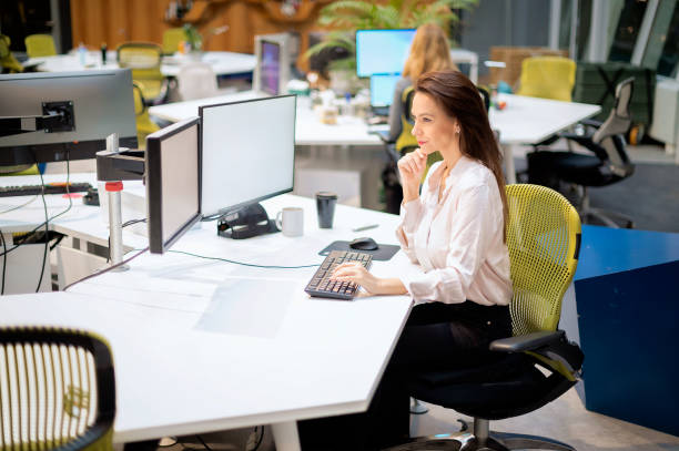 istock Brunette haired businesswoman sitting at the office and using computer for work 2168687811