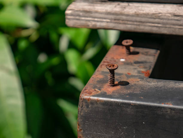 rusty iron bolts that are not attached properly to the iron