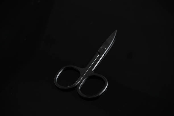 istock Close-Up of Small Black Scissors on a Dark Background Minimalist and Professional Tool 2168696111