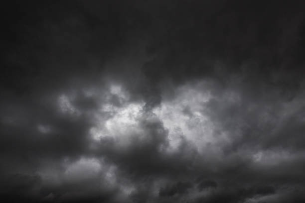 Dramatic dark storm rain clouds black sky background. Dark thunderstorm clouds rainny atmosphere. Meteorology danger windstorm disasters climate. Dark cloudscape storm disaster gloomy gray cloud sky