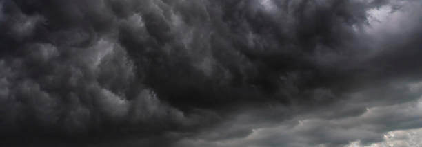 istock Banner Dramatic dark storm clouds black sky background. Dark thunderstorm clouds rainny season. Panorama Meteorology danger windstorm disasters climate. Dark cloudscape storm cloud with copy space. 2168698410
