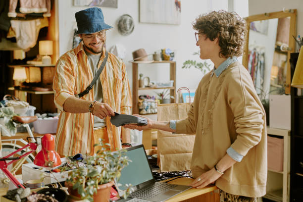 istock Smiling Man Paying for Purchase in Small Boutique 2168702173