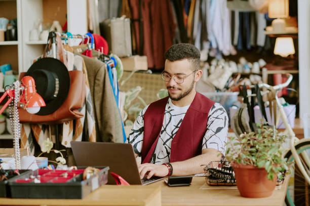 istock Concentrating Man Typing on Laptop in Cozy Workspace 2168702612