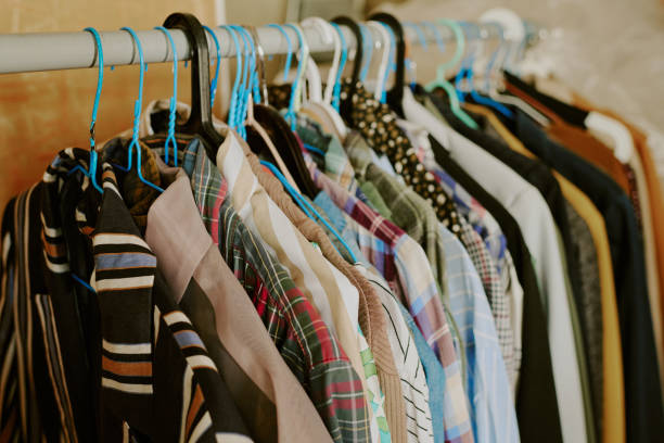istock Hanging Various Shirts on Clothes Rack in Cozy Room 2168702638