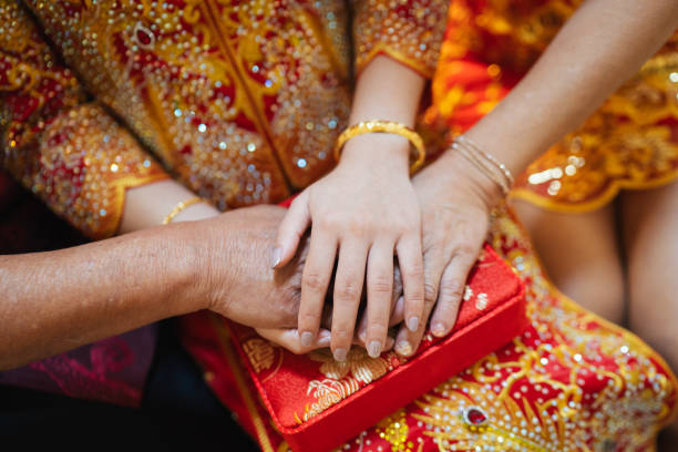 istock Hands stacked on the bride's hands for blessings in a traditional Chinese wedding. 2168703546