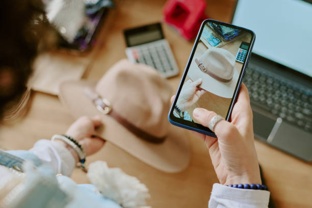 istock Taking Photo of Hat with Smartphone in Cozy Office 2168704123