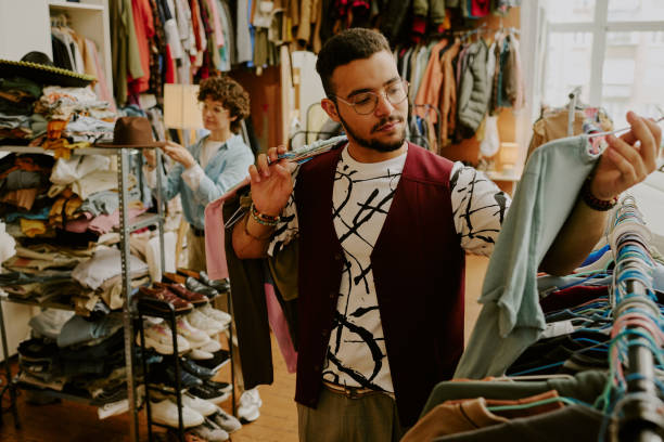 istock Man and Woman Browsing Clothes in Vintage Store 2168705321