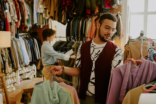 istock Selecting Clothes in Modern Boutique for Fashion Decision Making 2168705436