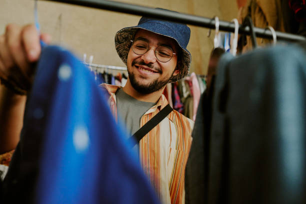 Smiling Man Shopping for Clothing in Thrift Store