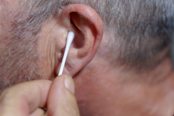 istock man cleaning his ears with a cotton swab 2168707562