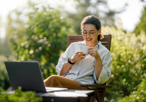 istock woman working on laptop in summer morning 2168708692