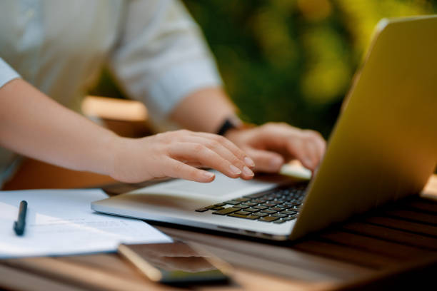 istock Person working on laptop in summer morning 2168708719
