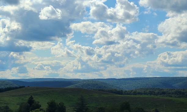 istock Rolling Hills Fading into the Distance under a Dramatic, Cloudy Sky 2168710892