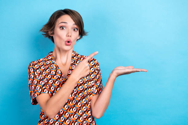 istock Portrait of impressed lady pouted lips indicate finger arm hold empty space isolated on blue color background 2168713673