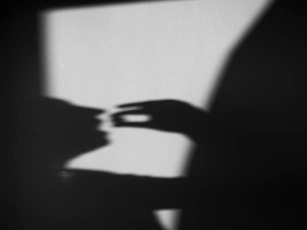 istock Shadow silhouette of woman projected on the wall taking pills 2168731118