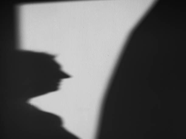 istock Shadow silhouette of woman projected on the wall black and white 2168731133