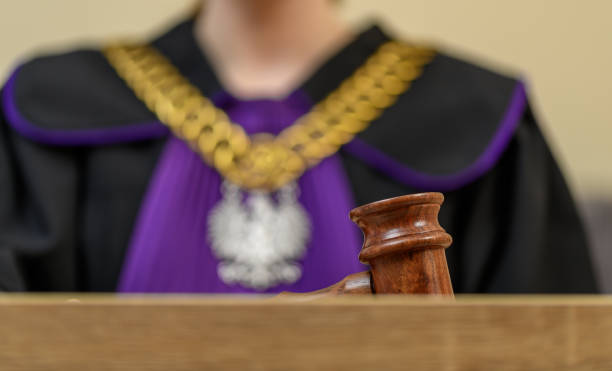 istock A Polish judge issues a court ruling wearing a black robe with a purple jabot 2168732514