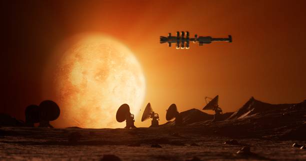 istock An alien landscape with antennas and a glowing planet, with a spaceship flying 2168735295