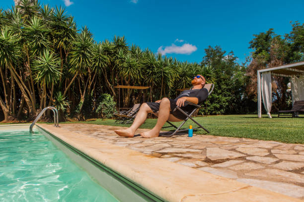 istock Swimming Pool Fun for middle aged man in public area inItaly 2168736464