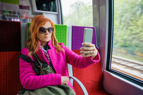 istock Woman in train using chatbot on her phone 2168737703