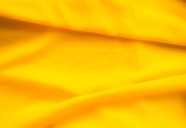 istock Yellow background cloth fabric orange color gradient texture pattern silk wave banner gold, fashion material backdrop poster for summer tropical travel holidays, satin mockup luxury premium. 2168738889