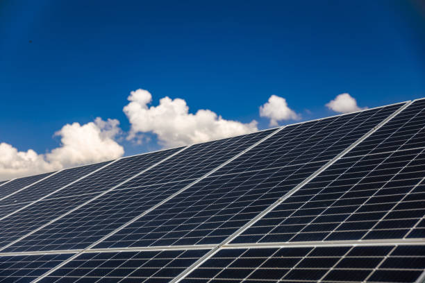 istock Slanted solar panels under the blue sky with white clouds 2168739211