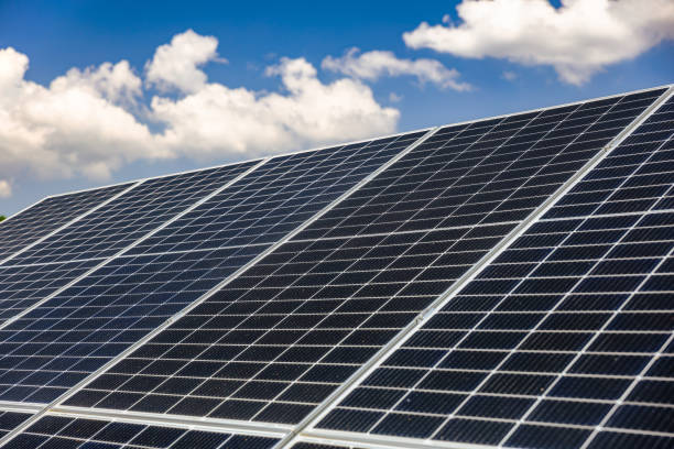 istock Slanted solar panels under the blue sky with white clouds 2168739215