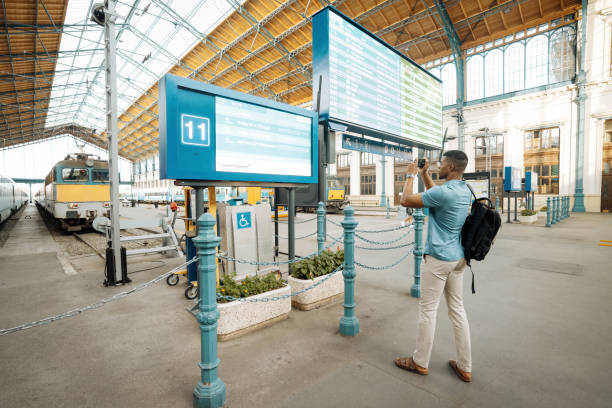 istock Millennial African American businessman going to work and using smart phone at the train station 2168741866
