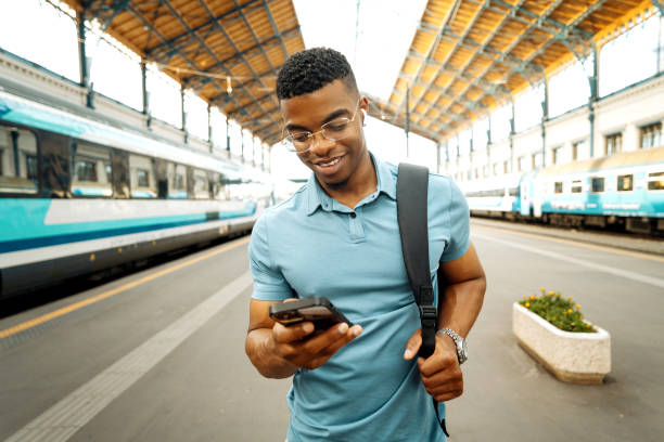 istock Millennial African American businessman going to work and using smart phone at the train station 2168741939
