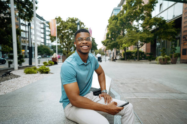 istock Millennial person of color going to work and using smart phone, sending text message 2168741956