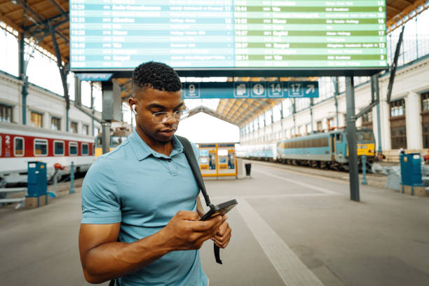 istock Black businessman going to work and using smart phone at the train station 2168742009