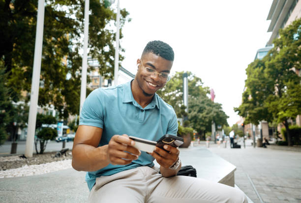 istock Millennial person of color going to work and using smart phone 2168742052