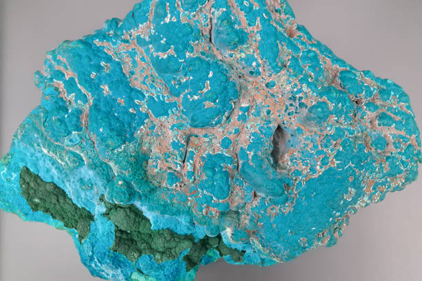 istock A vibrant, turquoise-colored mineral specimen with a rough, textured surface 2168742078