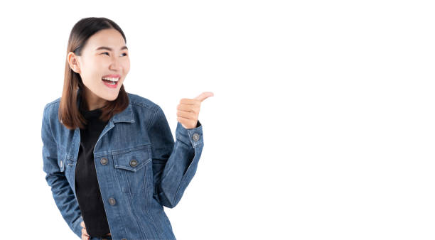 istock Smiling Woman in Denim Jacket Pointing 2168743187