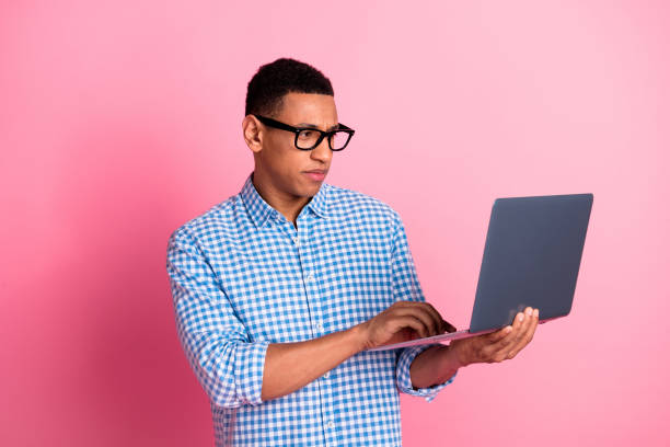 istock Photo of serious cool guy dressed checkered shirt communicating modern device emtpy space isolated pink color background 2168743587