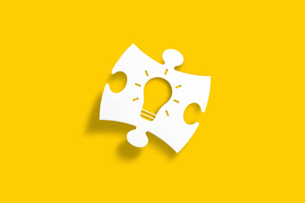 Creative idea, inspiration, new idea and innovation concept. White puzzle piece with light bulb shape on yellow background.