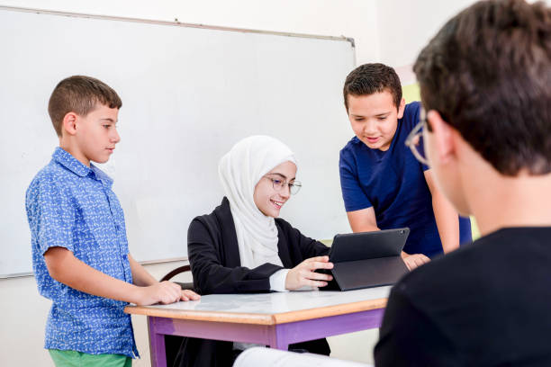 istock Students communicating with their teacher about there status and achievements 2168749048