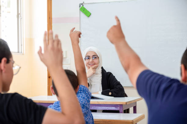 istock Students raising their hands to answer the teacher question 2168749896