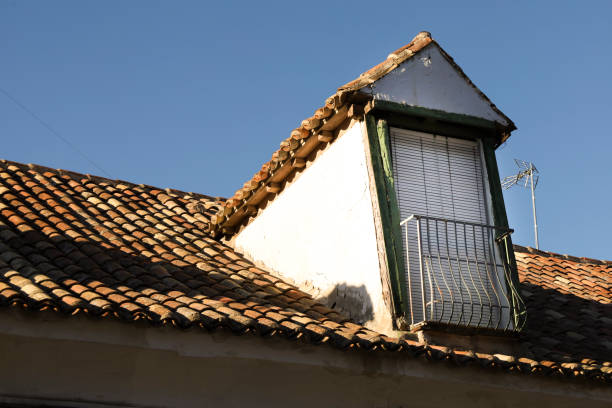 istock Broken and damaged roof with old window 2168751625