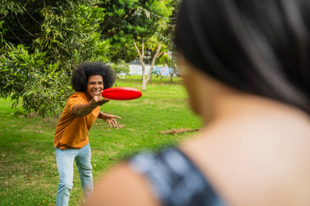 istock Couple are playing frisbee at the park 2168756846