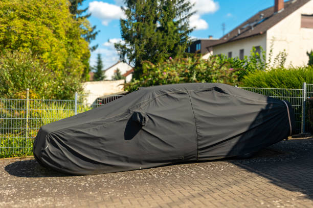 istock car is covered in a black tarp. 2168759142